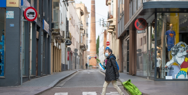 Una dona porta una rosa passejant per la Rambla | Roger Benet 