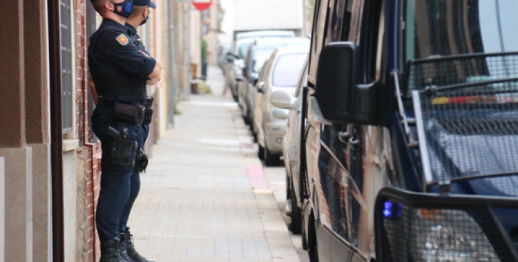 Dos agents de la Policia Nacional a la porta d'un domicili del carrer Fiveller