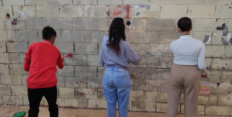 Joves pintant un grafiti, en una activitat inclosa també en el Pla de Joventut/ Pau Duran