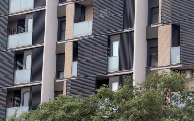 Un edifici de pisos amb la façana de color gris 